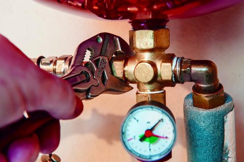 Gasfitter checking a gauge